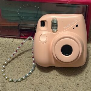 NWOT instax mini 7+ pink camera with a beaded lanyard (uses 4 AA batteries)